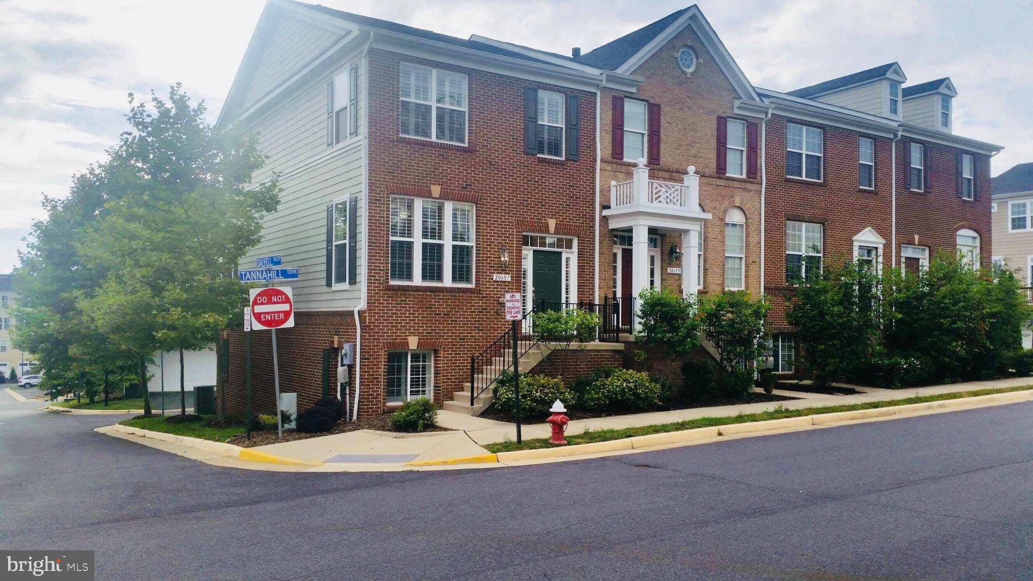 20657 Tannahill Terrace Ashburn, VA 20147 - Photo 1 of 28 a front view of a multi story residential apartment building