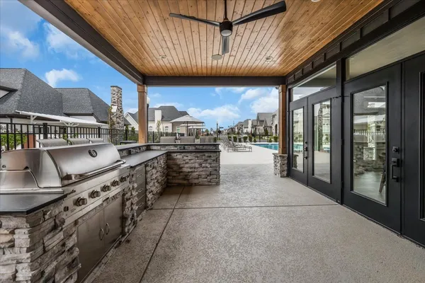 a open kitchen with stainless steel appliances granite countertop a stove a sink and a refrigerator