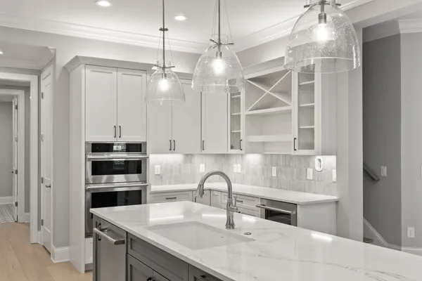 a kitchen with stainless steel appliances granite countertop a sink and a refrigerator