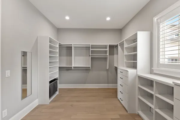 a room with walk in closet and window