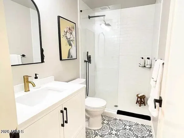 a bathroom with a sink toilet and shower