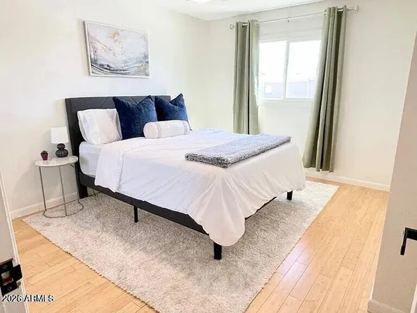 a bedroom with a bed and a window