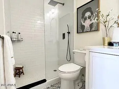 a bathroom with a toilet and a shower