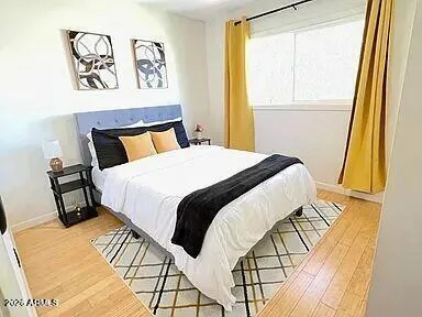 a bedroom with a bed and a window