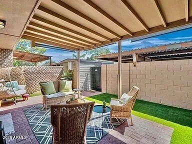 a view of a patio with a table chairs and a backyard