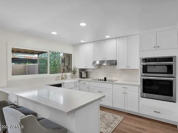 a kitchen with stainless steel appliances kitchen island granite countertop a sink and a stove