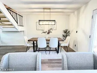 a living room with furniture a window and a dining table