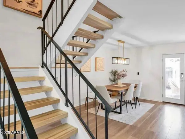 a view of entryway and hall with wooden floor