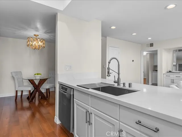 a kitchen with a sink table and chairs