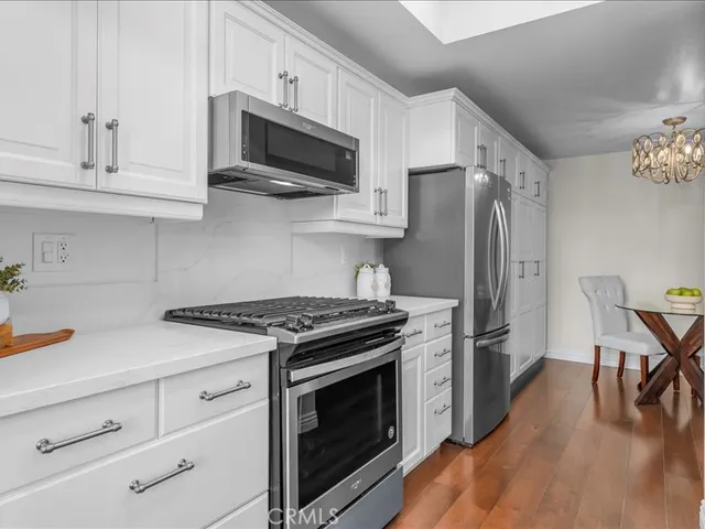 a kitchen with stainless steel appliances a stove a sink and a refrigerator