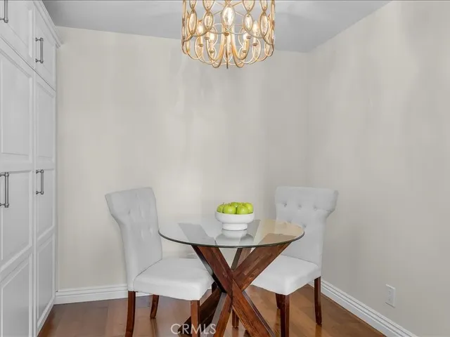 a view of a room with a table and chairs