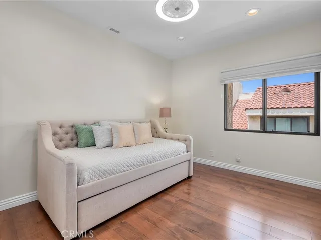 a room with a bed and painting on the wall