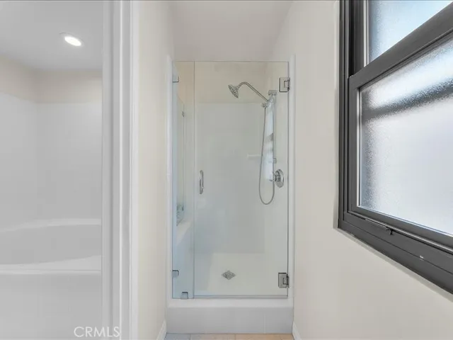 a bathroom with a glass shower door