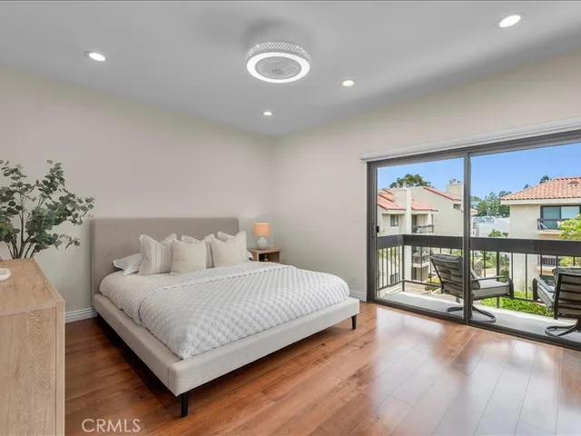 a bedroom with a large bed and a large window