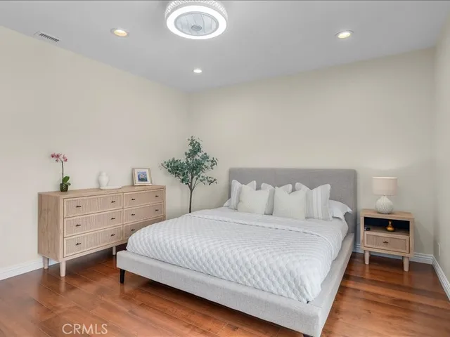 a bedroom with a large bed and a dresser