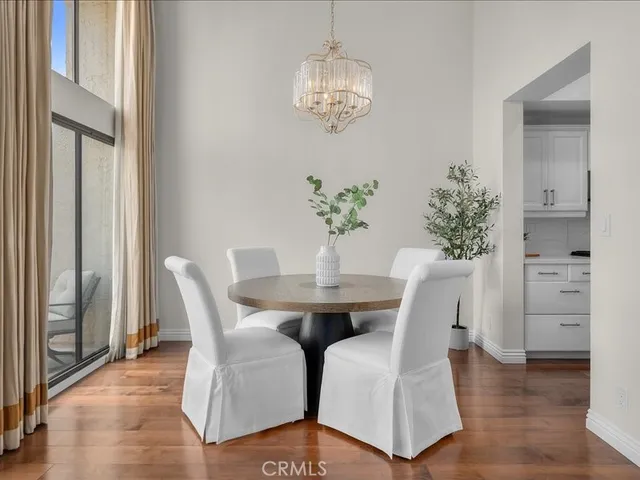 a view of a dining room with furniture wooden floor and a chandelier