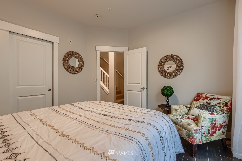 2115 201st Place Southeast, Unit B5 Bothell, WA 98012 - Photo 13 of 28 a bedroom with a bed and a wall painting