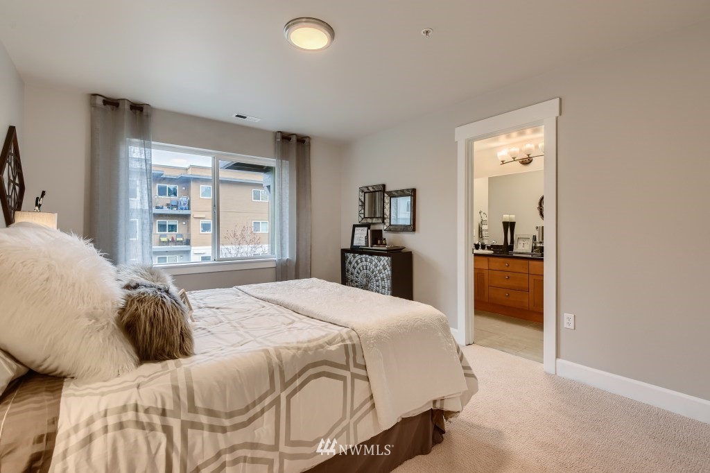 2115 201st Place Southeast, Unit B5 Bothell, WA 98012 - Photo 16 of 28 a bedroom with a large bed and a dresser