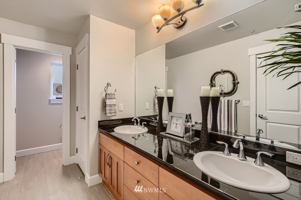 2115 201st Place Southeast, Unit B5 Bothell, WA 98012 - Photo 19 of 28 a bathroom with double vanity sinks a toilet and a mirror