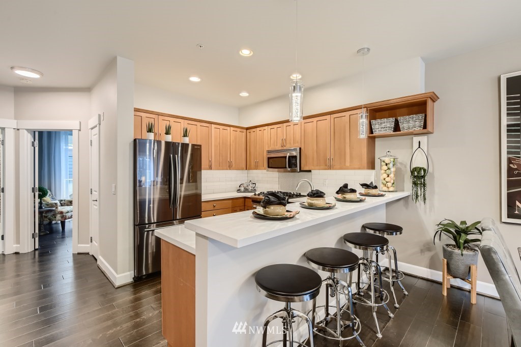 2115 201st Place Southeast, Unit B5 Bothell, WA 98012 - Photo 8 of 28 a kitchen with sink refrigerator dining table and chairs