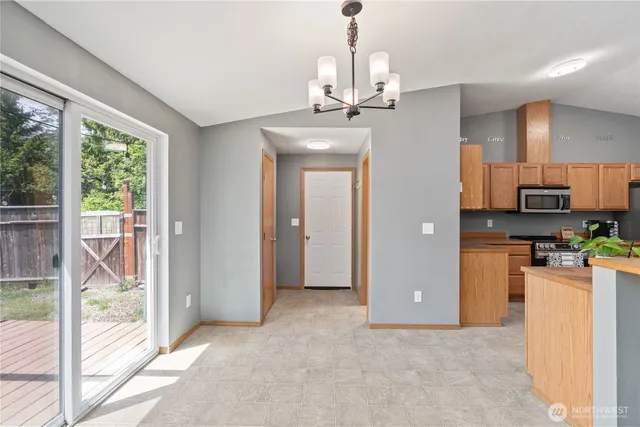 a view of a kitchen with refrigerator and wooden floor