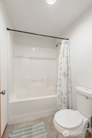 a bathroom with a toilet and shower