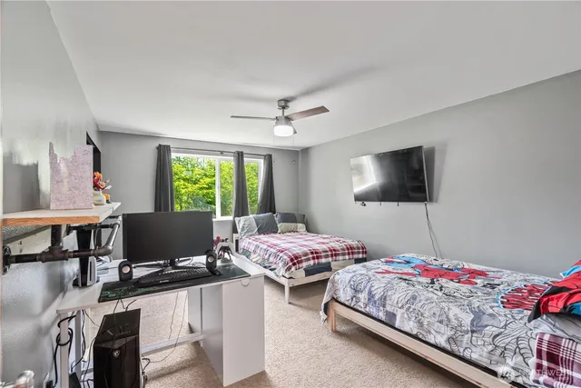 a bedroom with two beds and a flat screen tv