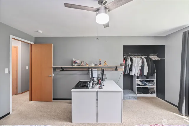 a kitchen with refrigerator and cabinets