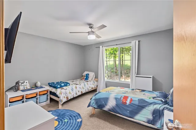 a bedroom with two beds and a window