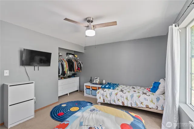 a bedroom with furniture and flat screen tv