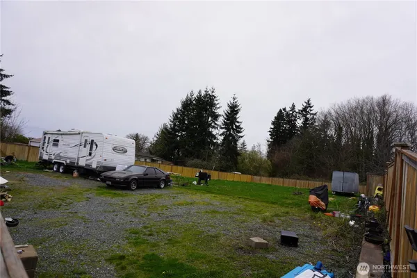 a view of a house with backyard and a cabin
