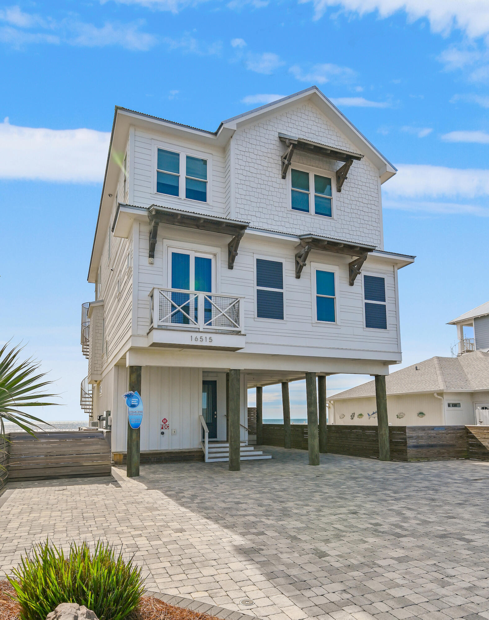 a house that has a lot of windows and palm trees