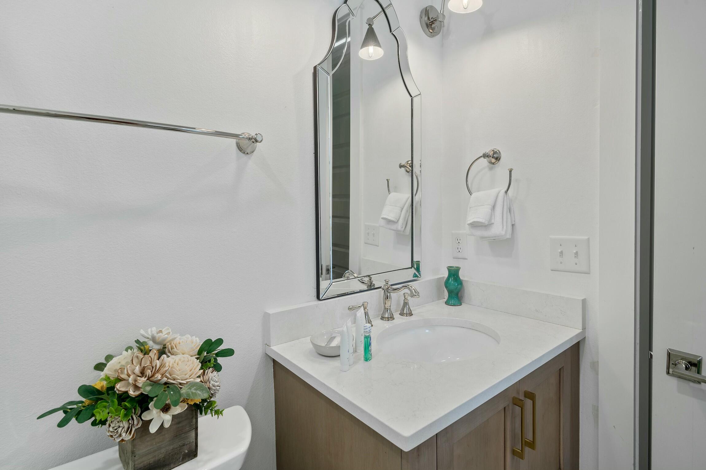 16515 Front Beach Road Panama City Beach, FL 32413 - Photo 27 of 46 a bathroom with a sink vanity and a mirror