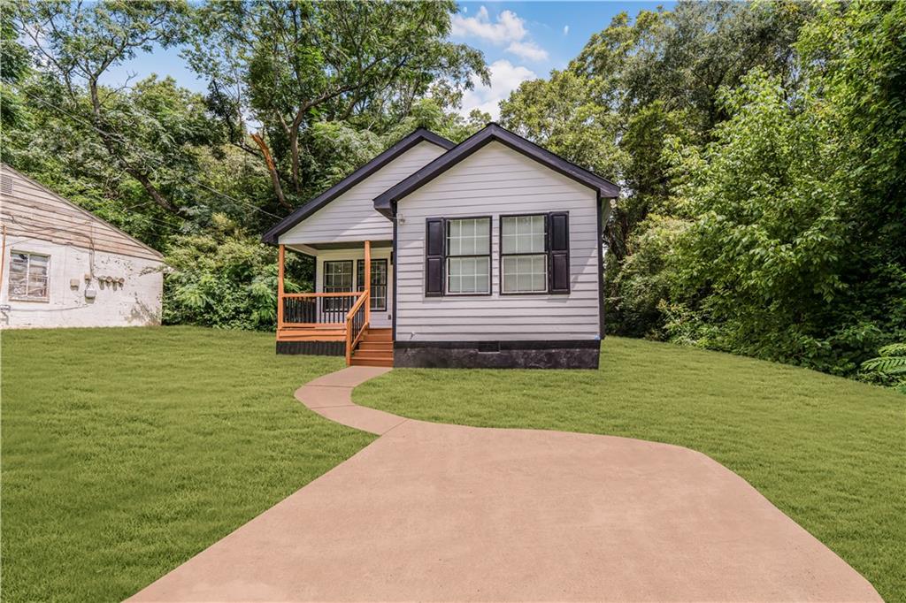 1111 Osborne Street Southwest Atlanta, GA 30310 - Photo 1 of 1 a front view of a house with a yard
