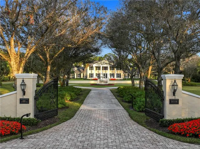 a front view of a house with yard and green space