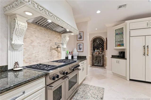 a living room with furniture ceiling fan and a large window