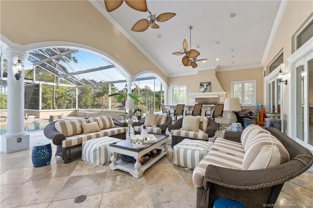 a living room with furniture a rug and white walls