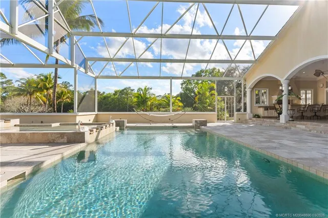 a bathroom with a granite countertop sink a mirror and shower