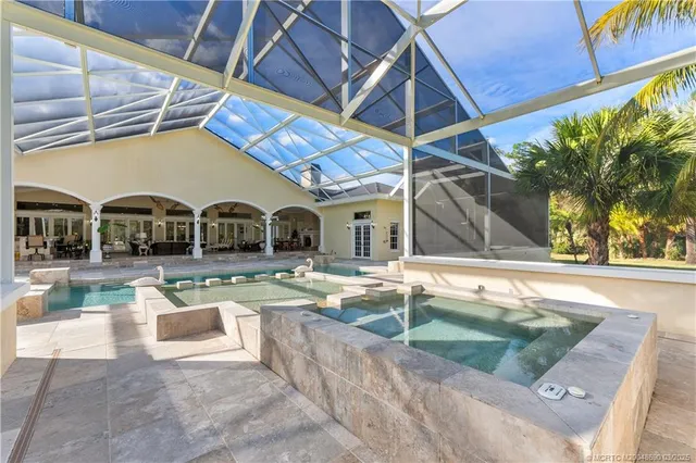 a bedroom with a bed mirror and window