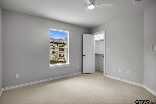 an empty room with windows and closet
