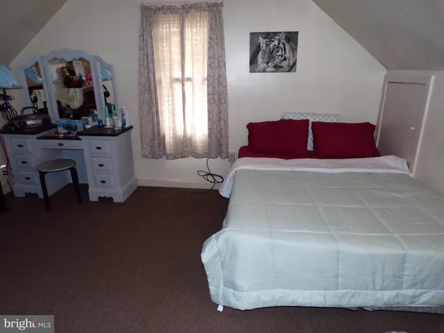 a bedroom with a bed and window