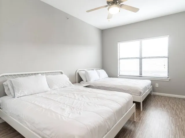 a bedroom with bed and window