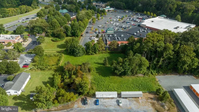an aerial view of residential houses with outdoor space and street view