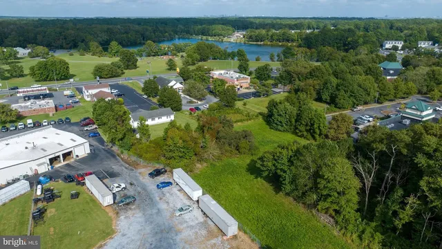 an aerial view of residential houses with outdoor space and trees