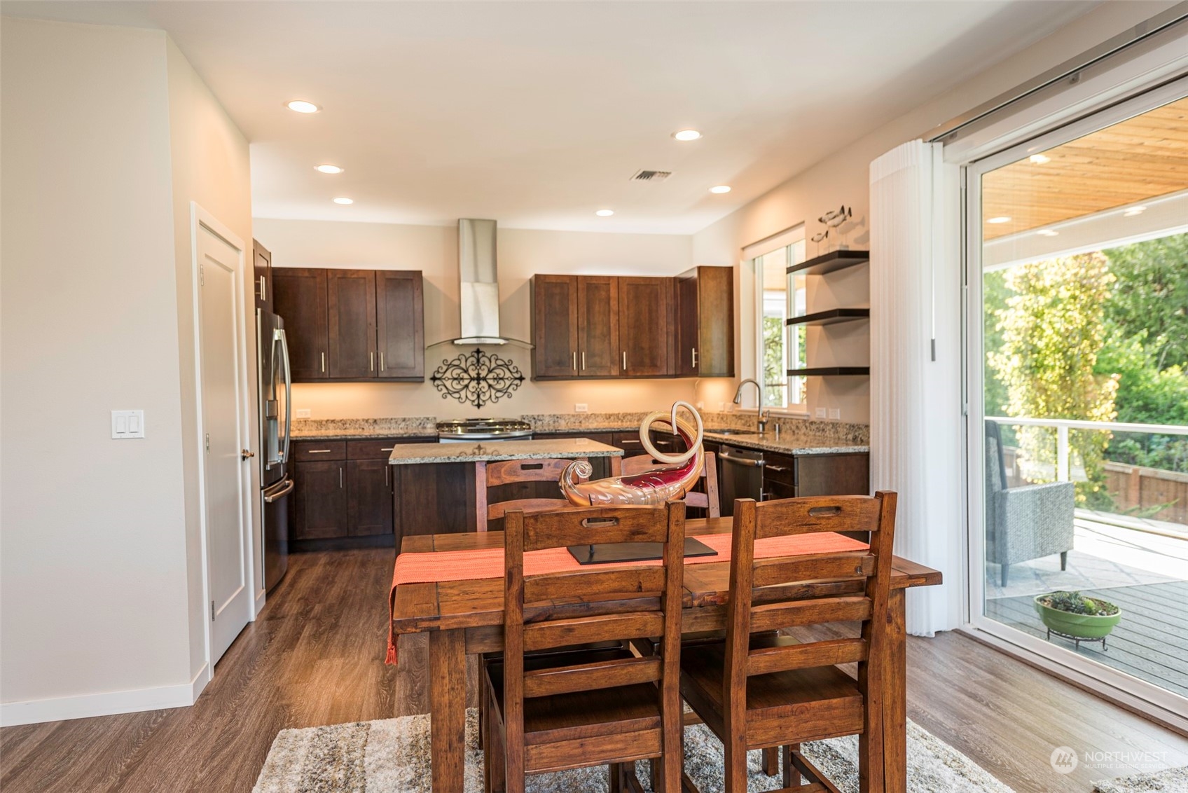 331 Morgison Loop Sequim, WA 98382 - Photo 11 of 39 a kitchen with a table chairs refrigerator and cabinets