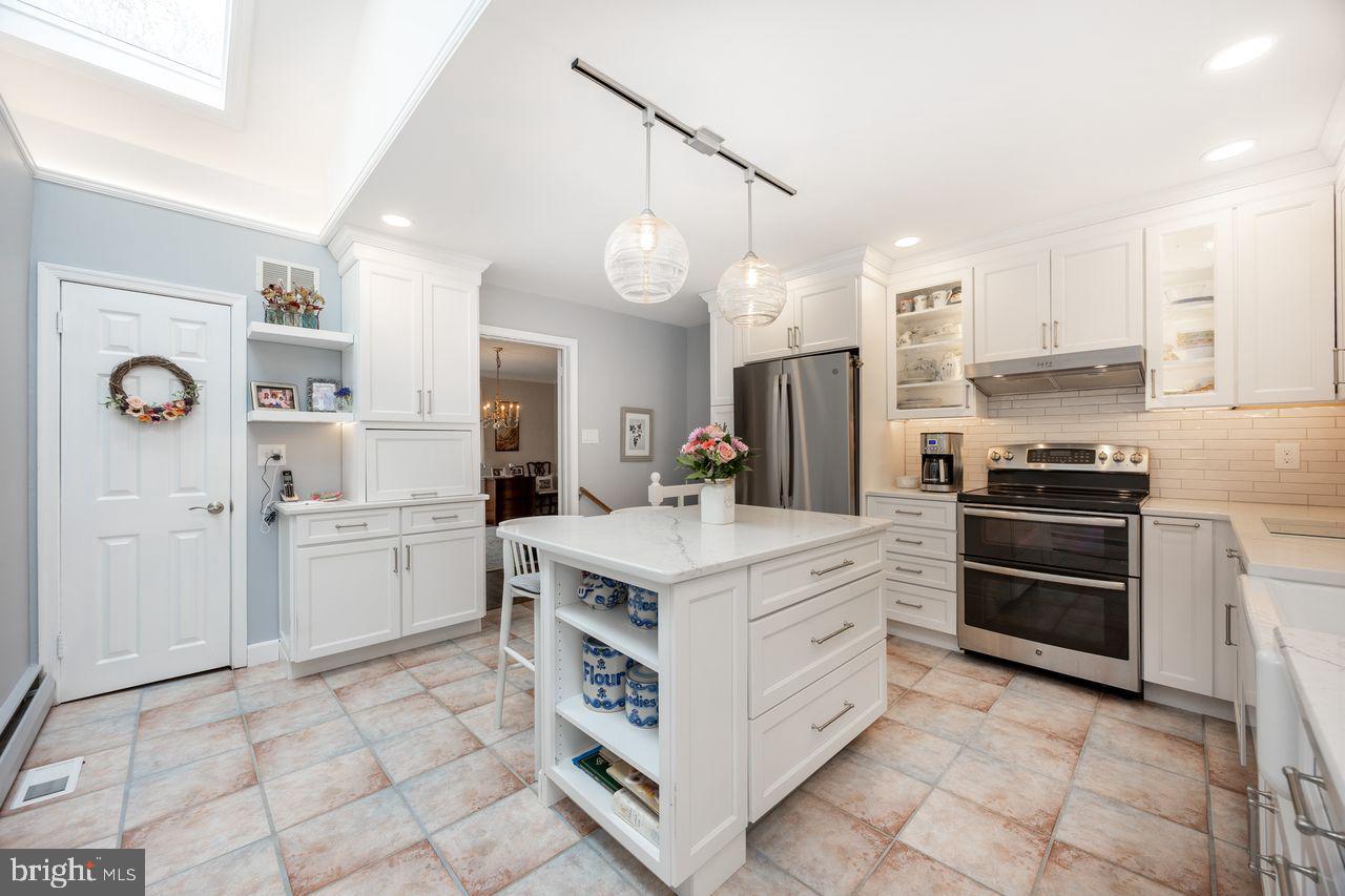 36 Long Lane Malvern, PA 19355 - Photo 11 of 44 a kitchen with white cabinets and stainless steel appliances