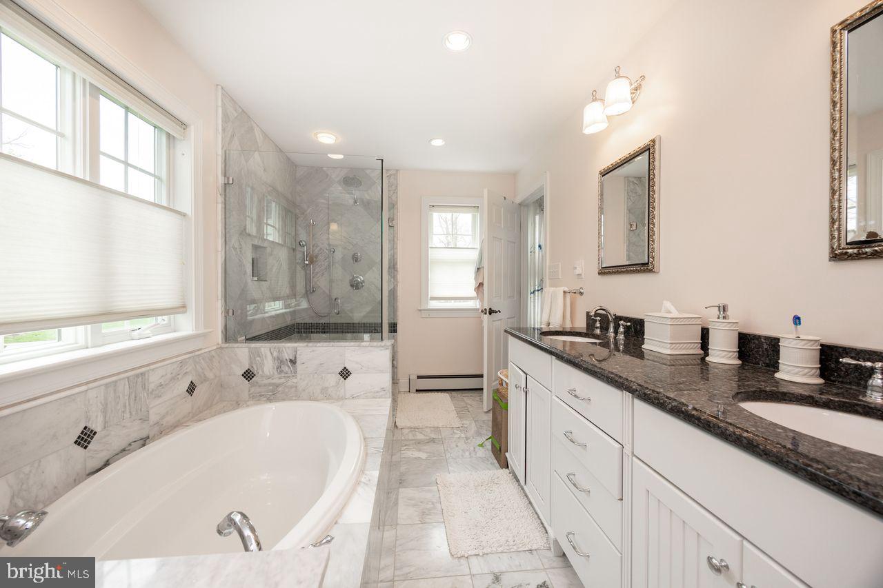 36 Long Lane Malvern, PA 19355 - Photo 22 of 44 a large white bathroom with a granite countertop sink mirror and bathtub