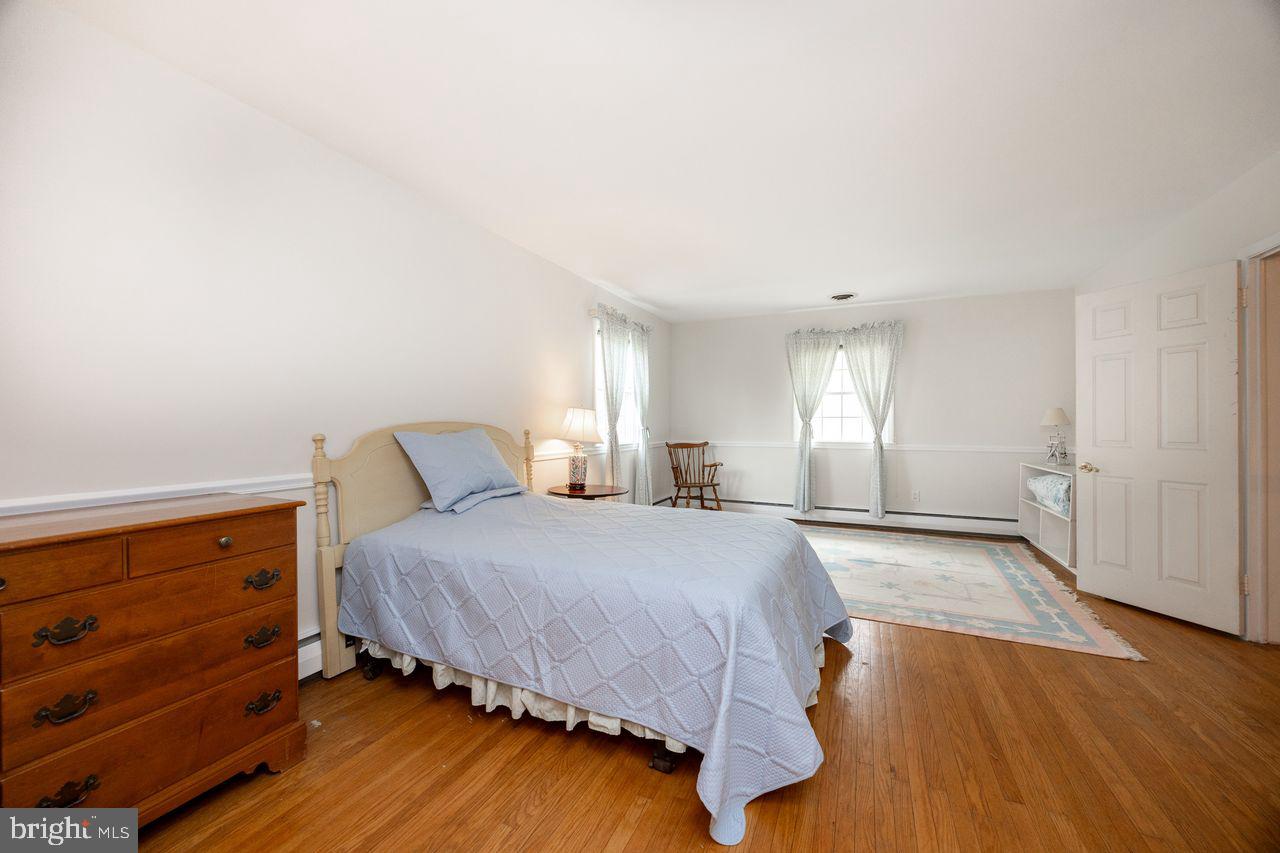 36 Long Lane Malvern, PA 19355 - Photo 27 of 44 a spacious bedroom with a bed and wooden floor