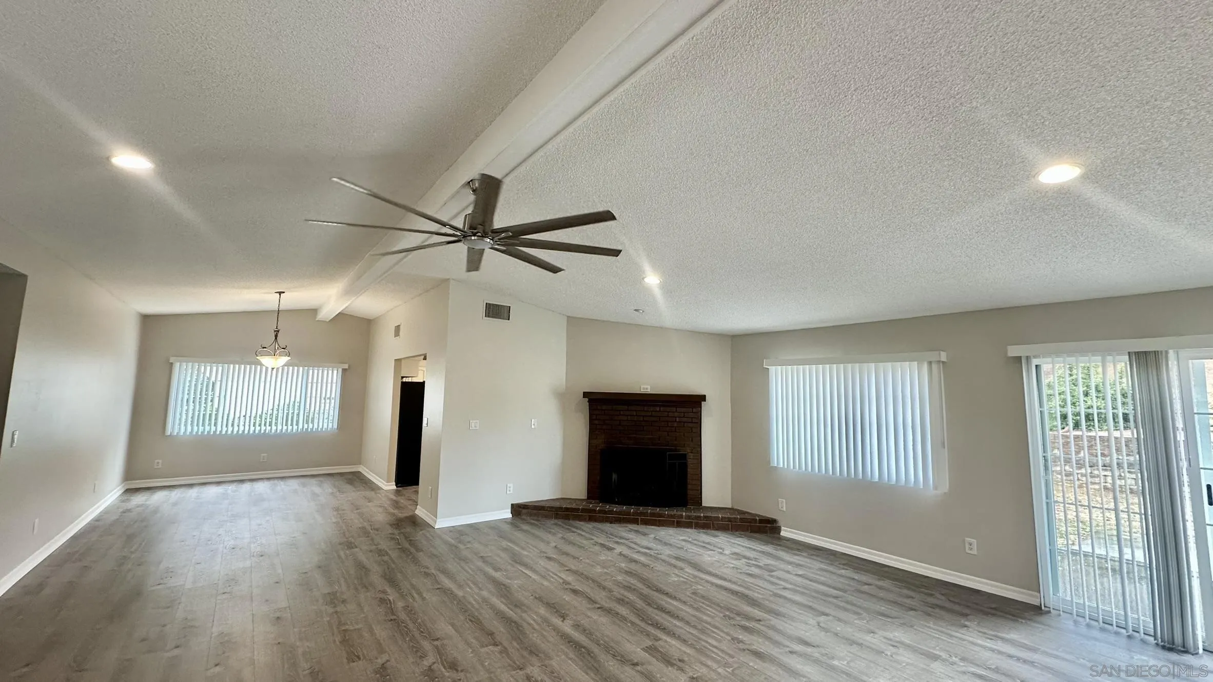 16142 Dartolo Road Ramona, CA 92065 - Photo 11 of 31 a view of an empty room with window and wooden floor