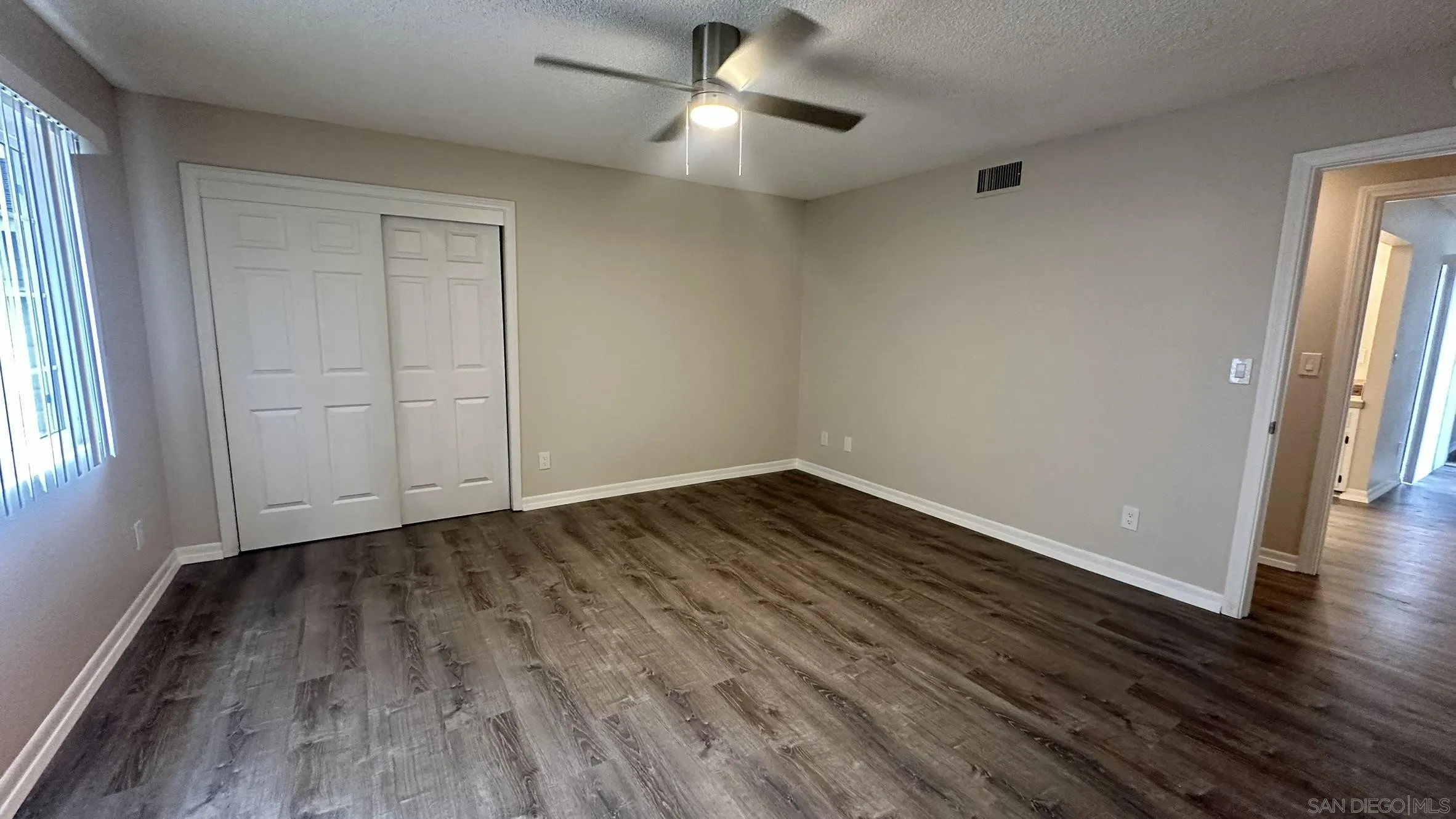 16142 Dartolo Road Ramona, CA 92065 - Photo 12 of 31 wooden floor in an empty room with a window